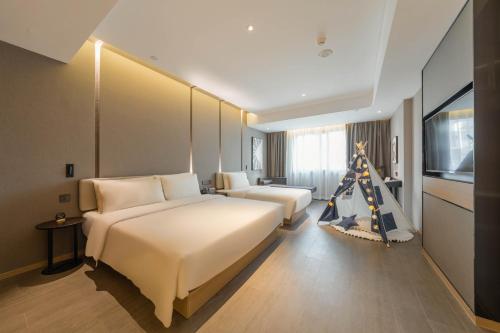a hotel room with a bed and a christmas tree at Atour Hotel Quzhou Nankong in Quzhou