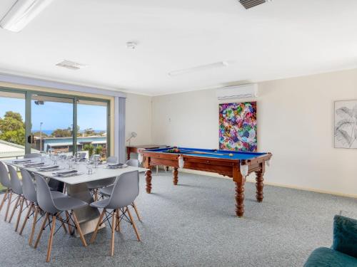a dining room with a pool table and chairs at Dive into Dorset 10 Dorset Court in Carrickalinga