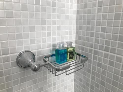 a bathroom with two soap bottles on a wall at Benja369 บ้านเบญจา in Ban Fang Min