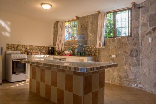 a kitchen with a large island in the middle at Hotel Terrazas Del Lago in San Antonio Palop&oacute;