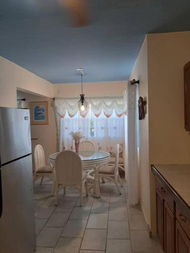 a kitchen and dining room with a table and chairs at Patmay Greenery. Fresh air, vacation get away. in Saint-James