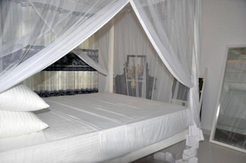 Ένα ή περισσότερα κρεβάτια σε δωμάτιο στο Villa Dineth