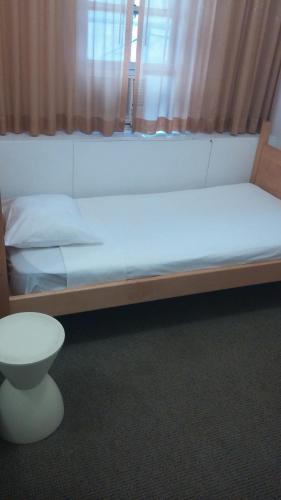a large white bed with a toilet in a room at West Side YMCA in New York