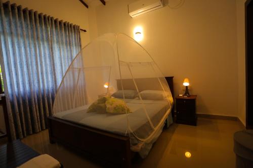 a bedroom with a bed with a canopy at Villa Sole in Kandy