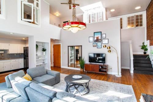 a living room with a couch and a table at Heart of the Old City- Minutes from Market Square in Knoxville