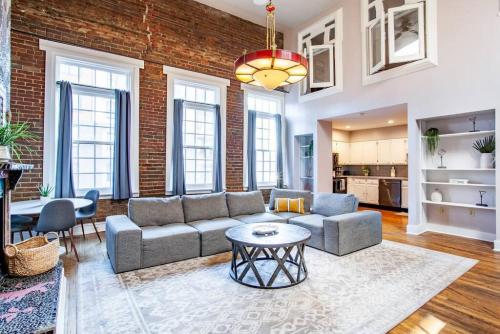 a living room with a couch and a table at Heart of the Old City- Minutes from Market Square in Knoxville