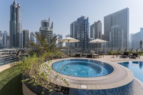 a hot tub with a view of a city skyline at HiGuests - JAM Marina Residence in Dubai
