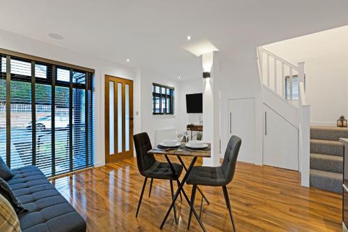 a dining room and living room with a table and chairs at Pitcorthie House in Dunfermline
