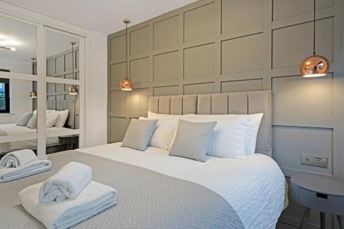 a bedroom with a large bed with towels on it at Pitcorthie House in Dunfermline