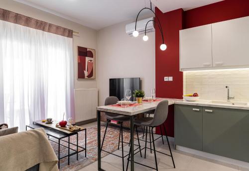 a kitchen with a table and chairs in a room at Zen Luxury Apartments in Xanthi