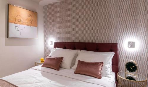 a bedroom with a large white bed with two pillows at Zen Luxury Apartments in Xanthi