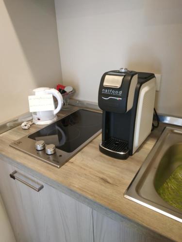 a toaster sitting on a counter next to a sink at Casa delle Ginestre Bike in Sanremo
