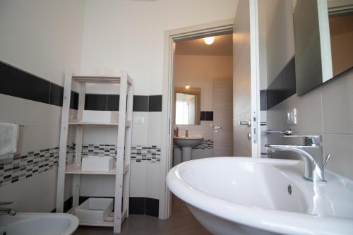 a bathroom with a white tub and a sink at Casa Del Corallo in Favignana