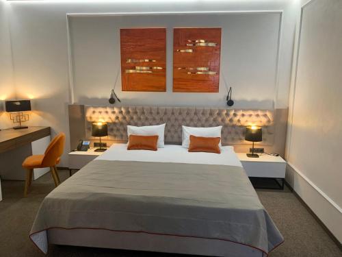 a bedroom with a large bed with two tables and two lamps at WISH Aqua&SPA Resort in Vishenki