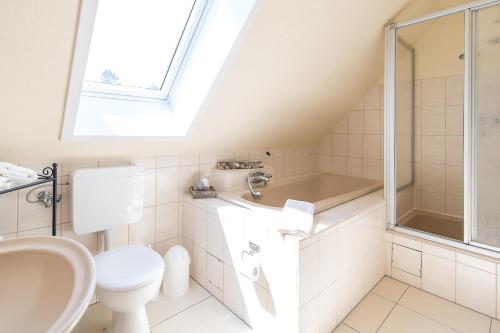 a bathroom with a toilet sink and a shower at Ferienwohnung Viola in Glücksburg