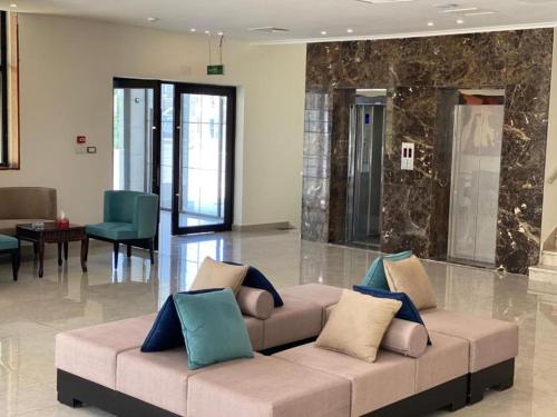 a living room with a couch in a lobby at Jordan View Hotel in Amman