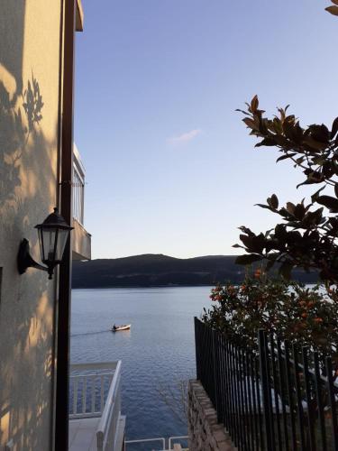 a view of a lake with a boat in the water at Apartmani Leženić Dada in Neum