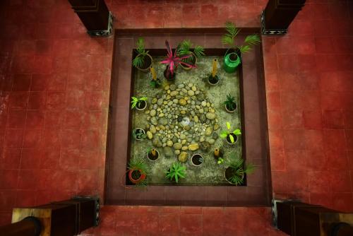 a wall with a painting of fruits and plants at Nivaasana Bed & Breakfast in Kalpetta