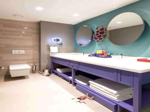 a bathroom with a sink and a large mirror at The Land Of Legends Kingdom Hotel - All-in Concept in Belek