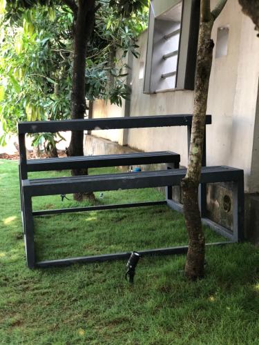 a bench sitting next to a tree next to a building at Royal residency in Tindummal