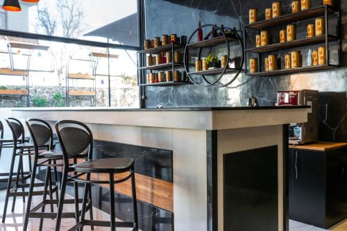a bar with stools and a fireplace in a restaurant at Misal Hotel Trabzon in Trabzon
