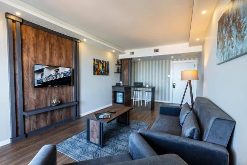 a living room with a couch and a table at Misal Hotel Trabzon in Trabzon