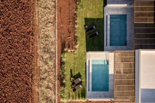 an overhead view of a pool next to a building at AKU Suites with private pools in Stalida