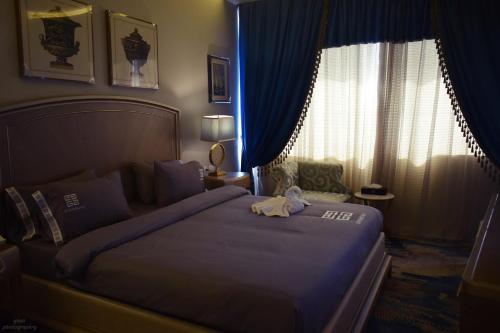 a hotel room with a bed with a towel on it at Fleet Club Mahrousa in Alexandria
