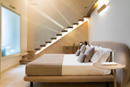 a bedroom with a bed and a staircase at Pollicastro Boutique Hotel in Lecce