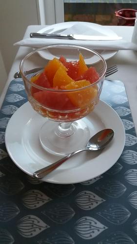 a bowl of fruit on a plate on a table at Eastdale Bed and Breakfast in North Ferriby