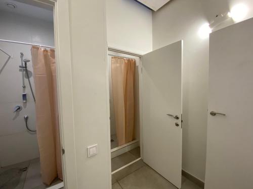 a bathroom with a shower and a walk in closet at Kyivpasservis HOSTEL in Kyiv