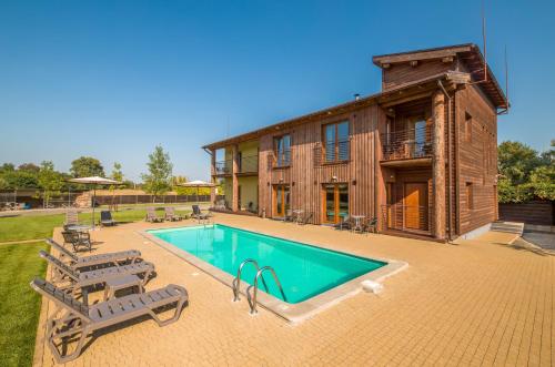 a house with a swimming pool in front of it at Eden Resort in Yasnogorodka