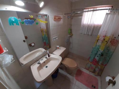 a bathroom with a sink and a toilet and a shower at TONGOY CASA INTIMA Y FAMILIAR in Coquimbo