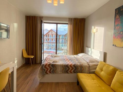 Postel nebo postele na pokoji v ubytování New Gudauri Alpen Apartments
