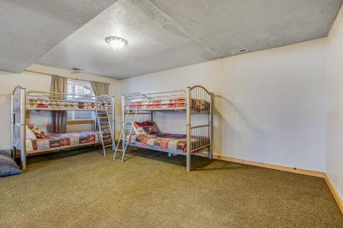 a room with three bunk beds in it at Worthen Cabin in Garden City