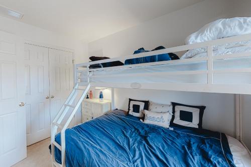 a bedroom with two bunk beds with blue sheets at Kensington Court -- 32759 Kensington in Frankford