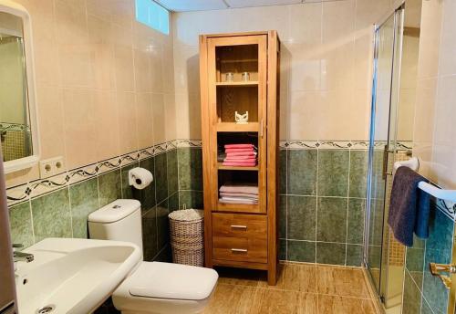 a bathroom with a toilet and a sink and a shower at Penthouse with stunning views in Guardamar del Segura