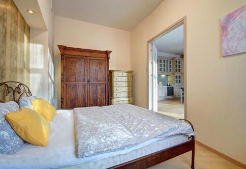 a bedroom with a bed and a dresser in it at Romantic City Center Apartment in Old Town in Vilnius