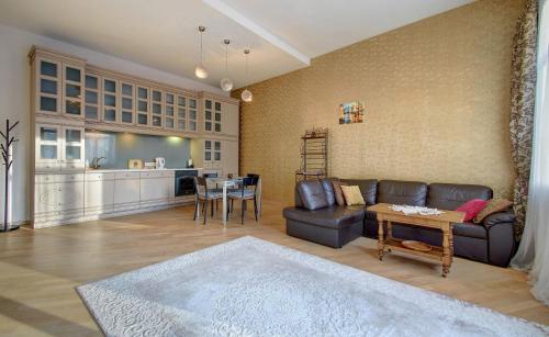 a living room with a couch and a table at Romantic City Center Apartment in Old Town in Vilnius