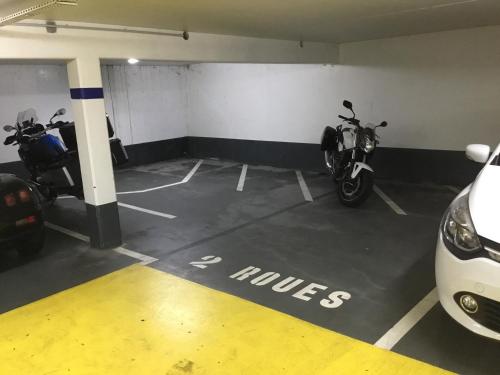 a parking garage with two motorcycles parked in it at Toul superbe appartement plein centre in Toul
