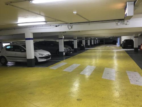 a parking garage with cars parked in it at Toul superbe appartement plein centre in Toul