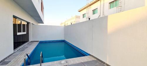 a swimming pool in the middle of a building at HAVANA HOLIDAY HOMES MIRDIF in Dubai