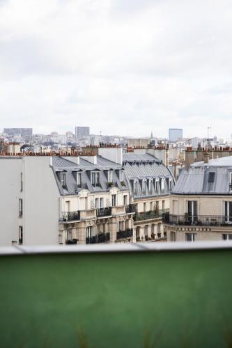 a view of a city from a window at Hôtel du Sentier in Paris