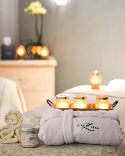 a table with a pillow with four candles on it at Hotel ZaZa Dallas in Dallas