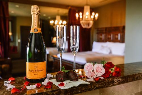 a bottle of wine and two champagne glasses on a counter at Hotel ZaZa Dallas in Dallas