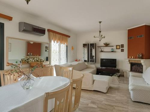 a kitchen and living room with a table and a couch at Spacious House in a Quiet Neighbourhood in Ierapetra