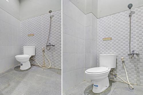 a bathroom with a toilet and a shower at Super OYO 90767 Gm Guest House in Wonogiri