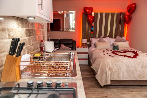 a kitchen with a bed and a stove in a room at Meridian Serviced Apartments in Bradford
