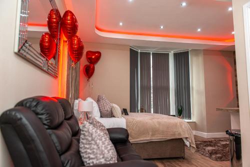 a bedroom with a bed and red balloons at Meridian Serviced Apartments in Bradford