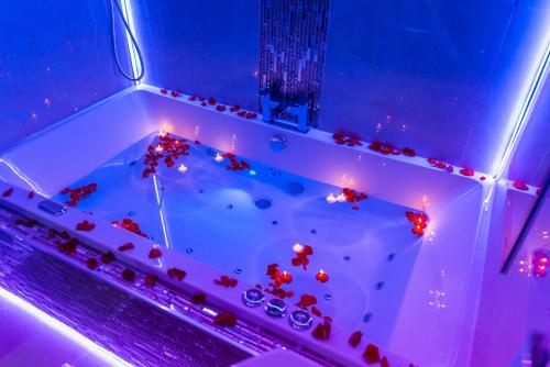 a bathtub filled with rocks and lights in a room at Meridian Serviced Apartments in Bradford